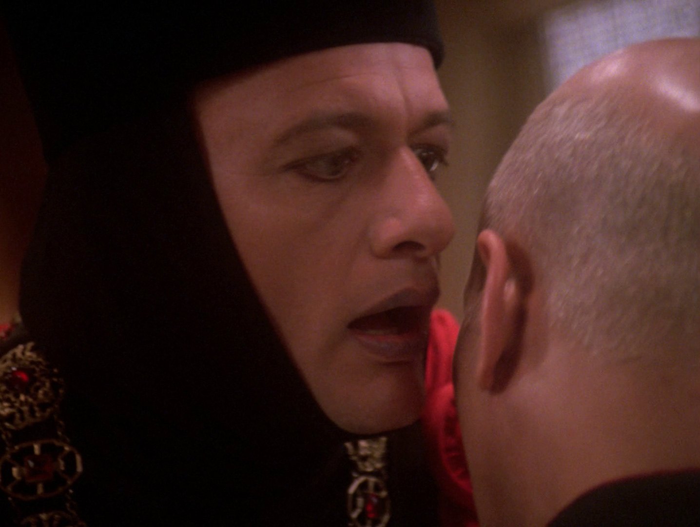 Photo: Judge Q about to whisper something into Picard's ear
