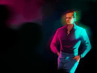 
        Q in a purple dress shirt and blue jeans at a party, leaning to a wall, not participating
      