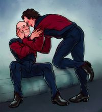 
        Picard is sitting on a couch while Q leans over him for a forehead touch.
      