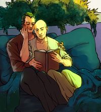 
        Q is holding Picard in bed, both wearing casual civilian clothing, while Picard is reading and touching Q's face
      
